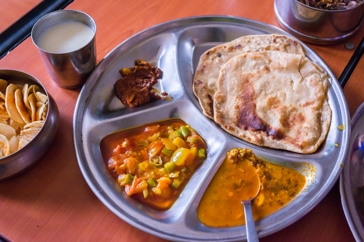 Indian thali with roti, dal, sabzi, and buttermilk